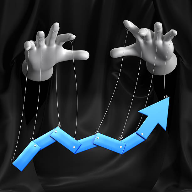Puppeteer controlling the trend on a graph stock photo