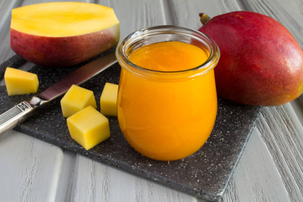 Puree with mango and ingredient on the gray cutting board stock photo
