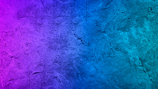 Purple blue teal green abstract background. Gradient. Toned rough surface texture. Painted concrete wall. Colorful background with copy space for design.