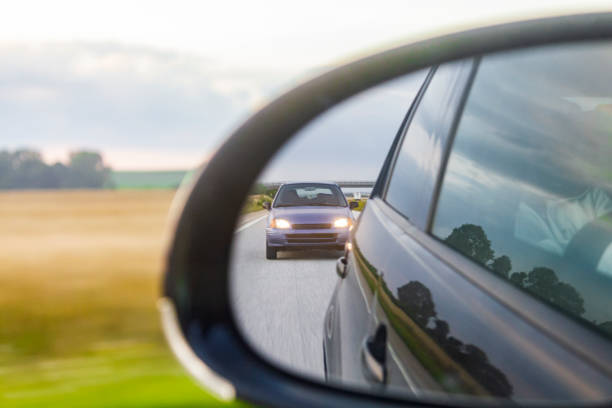 Purple car in the rearview mirror on the highway in Malmö Sweden. stock photo