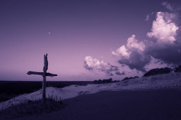 Purple landscape with wooden Cross or crucifix.  Concept for Lent Season, Holy Week, Palm Sunday and Good Friday. Purple landscape with wooden Cross or crucifix.  Concept for Lent Season, Holy Week, Palm Sunday and Good Friday. Late evening. lent stock pictures, royalty-free photos & images