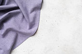 istock Purple napkin on the left side of the abstract background with copy space, food background 1325789967