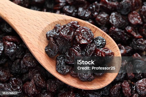 istock Purple raisins on a wooden spoon 182516607