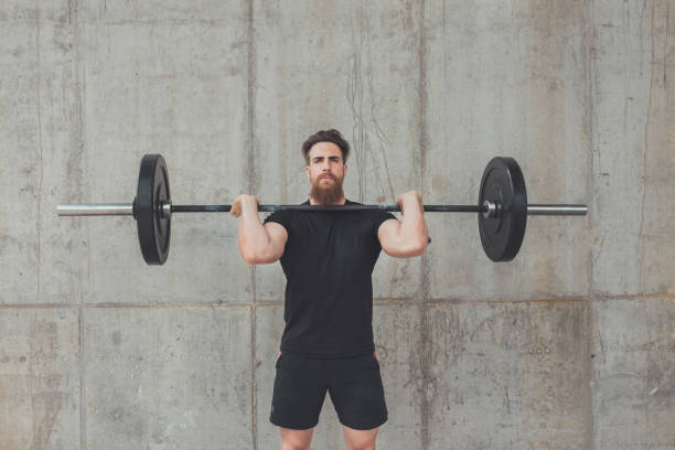 Push press exercise performed by a professional cross fit instructor stock photo