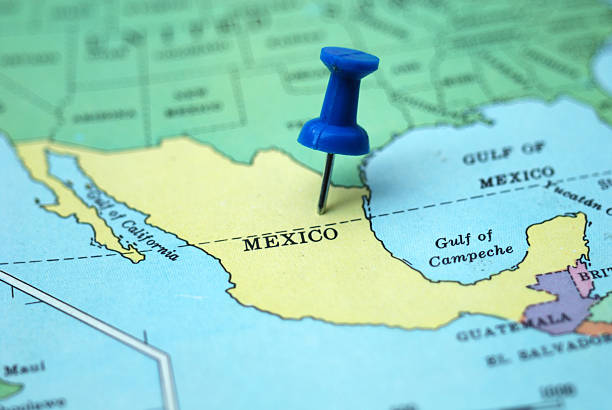 A pushpin marking Mexico as a travel destination on a map stock photo