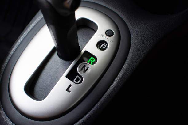 Put a gear stick into R position, (Reverse). stock photo