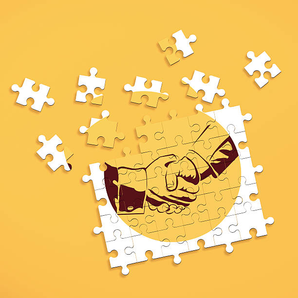 Puzzle pieces forming image of shaking hands stock photo