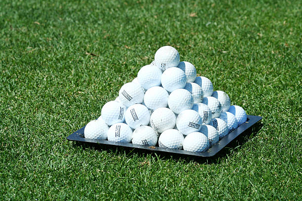 Pyramid of practice golf balls stock photo