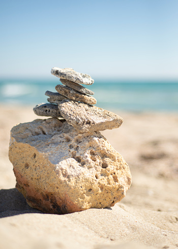 A pyramid of stones on the seashore. Themes of eternity. Health topics. Esoteric themes.