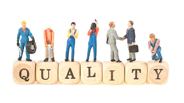 quality word with figurines the word quality with little workers on it models me stock pictures, royalty-free photos & images