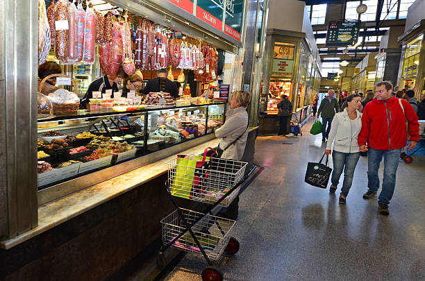 Queen Victoria Market - Melbourne Melbourne, Australia - April 12, 2014: Shoppers buy meat at Queen Victoria Market. It is a major landmark and the largest open air market in the Southern Hemisphere. queen victoria market stock pictures, royalty-free photos & images