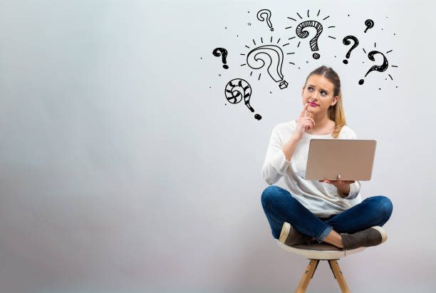 Question marks with young woman using her laptop Question marks with young woman using her laptop on a grey background question mark photos stock pictures, royalty-free photos & images