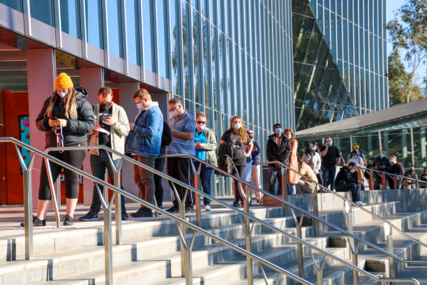 Queues of people lining up at Covid-19 vaccination hub at Melbourne Convention Centre in Victoria, Australia stock photo