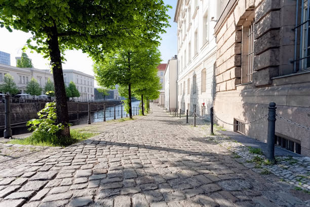 Quiet empty side street in historic district, along a river, on a spring afternoon - Berlin, Mitte, 2018 A quiet empty side street in historic district, along a river, on a spring afternoon - Berlin, Mitte, 2018 historic district stock pictures, royalty-free photos & images