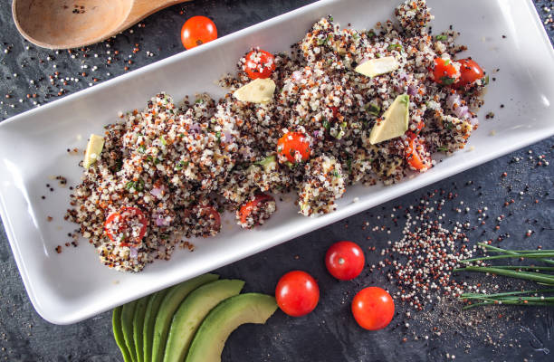 Quinoa salad plate with avocado and vegetables stock photo
