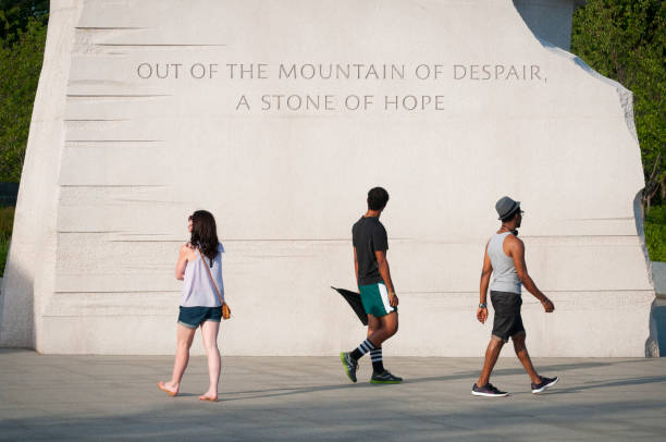 Quote at Martin Luther King Jr Memorial in Washington DC Washington DC, USA - June 16, 2012: Three people visiting the Martin Luther King Memorial Jr Memorial walk past a quote that reads, "Out of the Mounatain of despair, a stone of hope." mlk memorial stock pictures, royalty-free photos & images