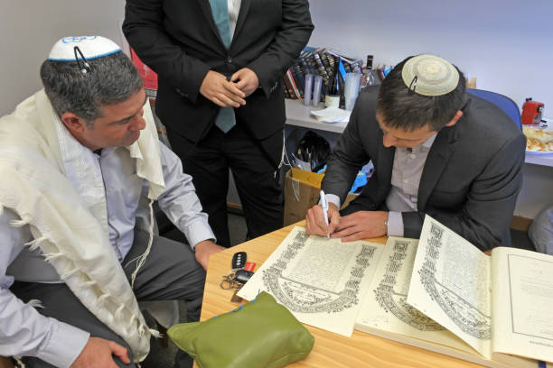 Rabbi signing Ketubah Jewish Prenuptial Agreement AUCKLAND  - OCT 31 2018:Rabbi signing Ketubah Jewish Prenuptial Agreement document in a traditional Jewish marriage that outlines the rights and responsibilities of the groom, in relation to the bride. ketubah stock pictures, royalty-free photos & images