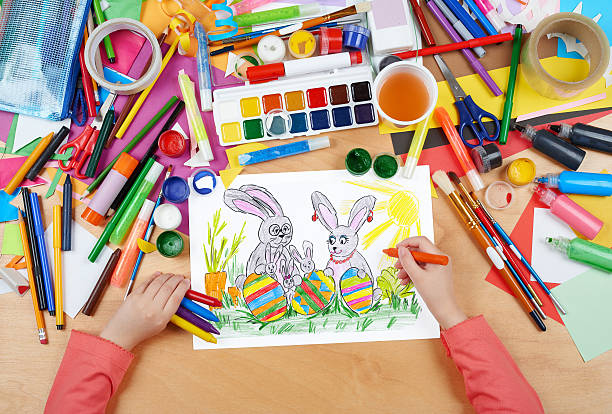 rabbit family on meadow with eggs, easter holiday child drawing stock photo