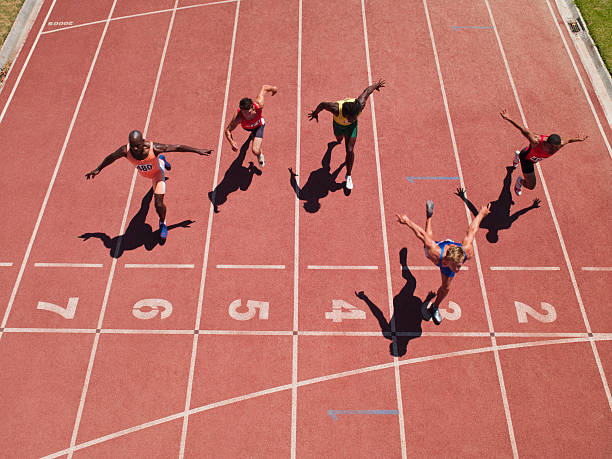 racers at the start line on a track - racer stockfoto's en -beelden