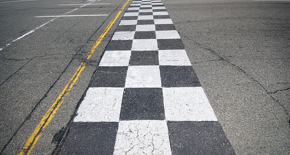 A finish-line painted on an asphalt setting.