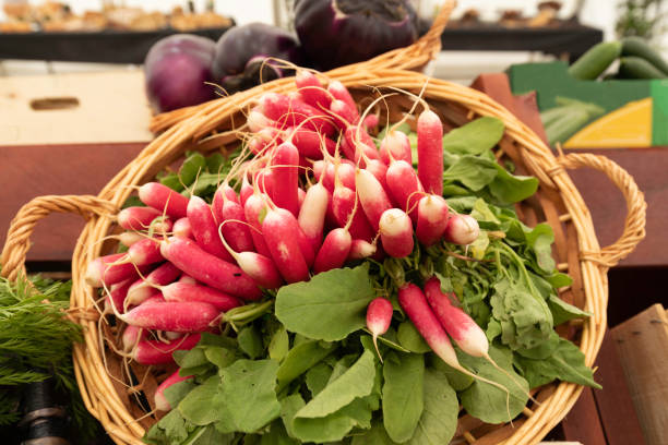 Radishes in a basket on a market stall stock photo