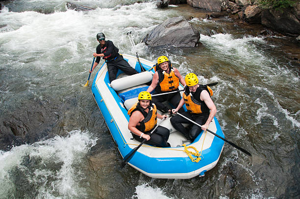Rafting in Colorado A family white water rafts down the Clear Creek in Colorado. inflatable raft stock pictures, royalty-free photos & images