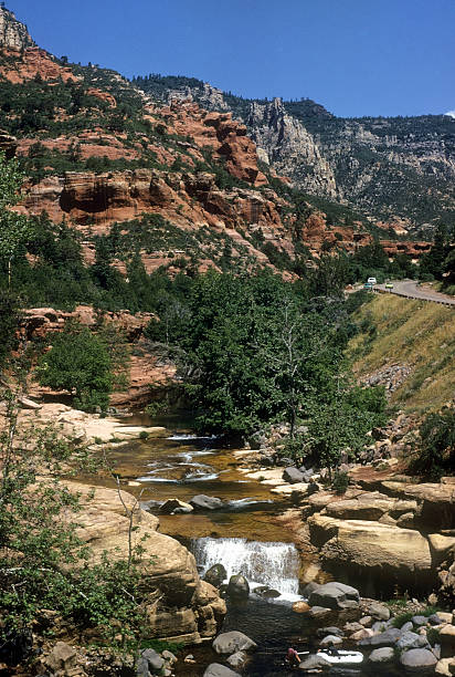 Rafting near Oak Creek Canyon A pair of rafters on the water (at the very bottom of the photo), navigating a river near Oak Creek Canyon hearkencreative stock pictures, royalty-free photos & images