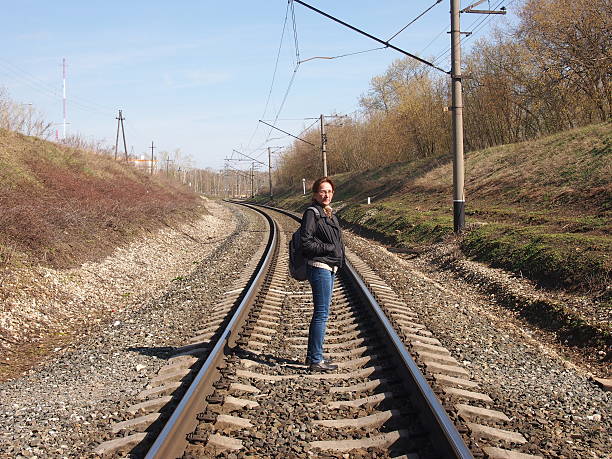 Girl walking on train tracks ~ People Photos on Creative 