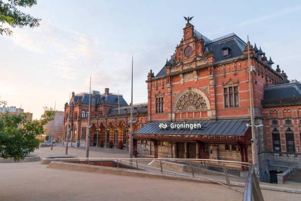 Railroad Station Groningen GRONINGEN - THE NETHERLANDS, August 9, 2019: the monumental railroad station in Groningen on an early morning. groningen city stock pictures, royalty-free photos & images
