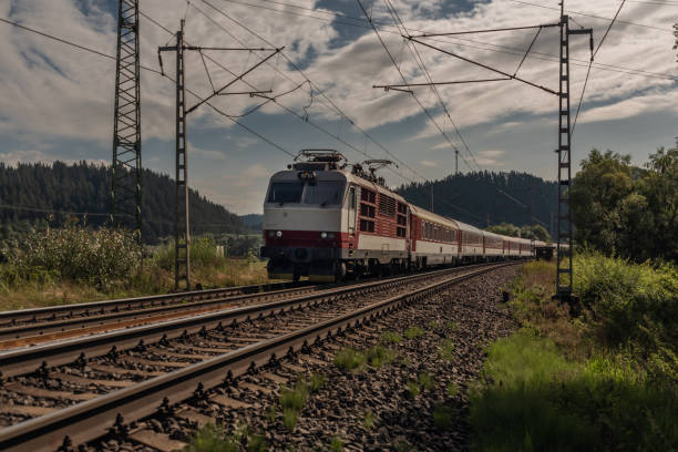 Railway electric track near Liptovsky Hradok station in summer sunny morning stock photo