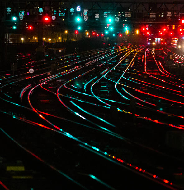 Railway tracks illuminated at night in the city stock photo