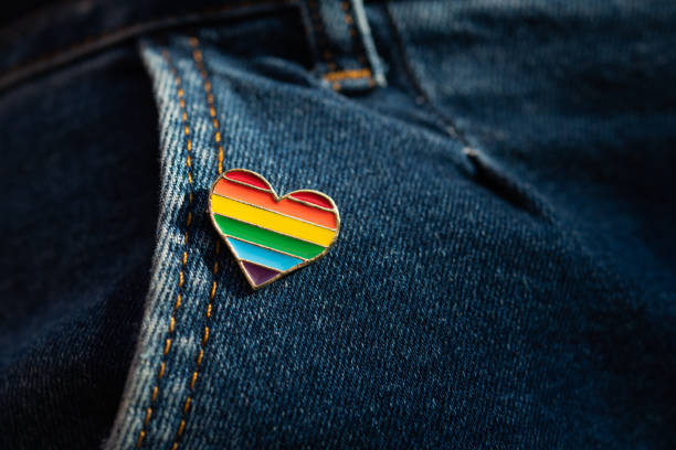 Rainbow color lgbt heart badge on jeans. Rainbow color lgbt heart badge on jeans. Closeup photo. Freedom concept parade. lgbtqia pride event stock pictures, royalty-free photos & images