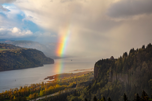 A rainbow forms after a passing storm in the Columbia River Gorge.