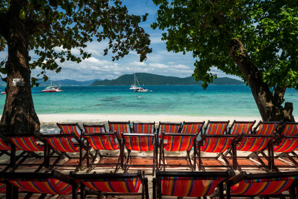 Rainbow deck beach chairs at Hey island, Phuket Rainbow deck beach chairs by trees and white sand with turquoise andaman sea in Hey island, Phuket, Thailand. Famous travel destination or summer holiday maker of Siam. hey beach stock pictures, royalty-free photos & images