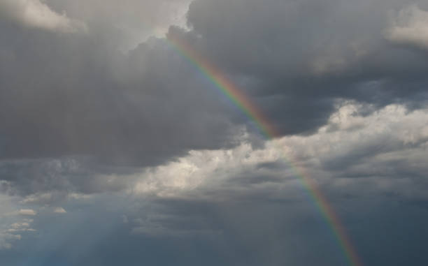 Rainbow in a Dark Sky A rainbow appears in a dark sky over the Grand Canyon near Flagstaff, Arizona, USA. jeff goulden rainbow background stock pictures, royalty-free photos & images