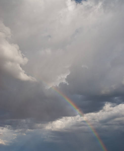 Rainbow in a Dark Sky A rainbow appears in a dark sky over the Grand Canyon near Flagstaff, Arizona, USA. jeff goulden rainbow stock pictures, royalty-free photos & images