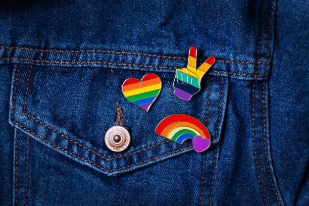 Rainbow lgbtq flag badges against denim background, pride month stock photo