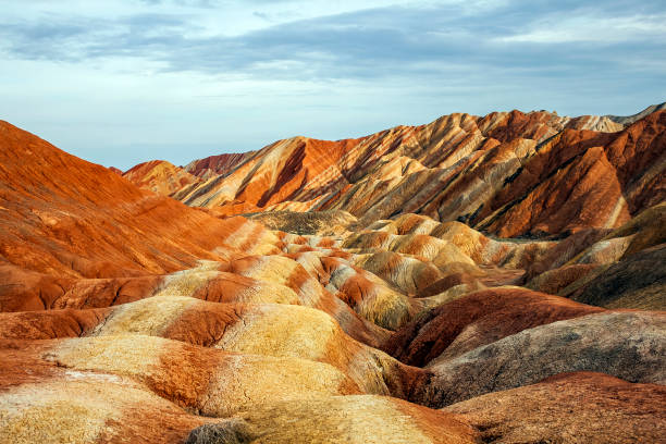 Rainbow Mountains in Zhangye Danxia Landform Geological Park. Panoramic View of Rainbow Mountains Geological Park. Stripy Zhangye Danxia Landform Geological Park in Gansu Province, China. Valley on a Sunny Day. danxia landform stock pictures, royalty-free photos & images