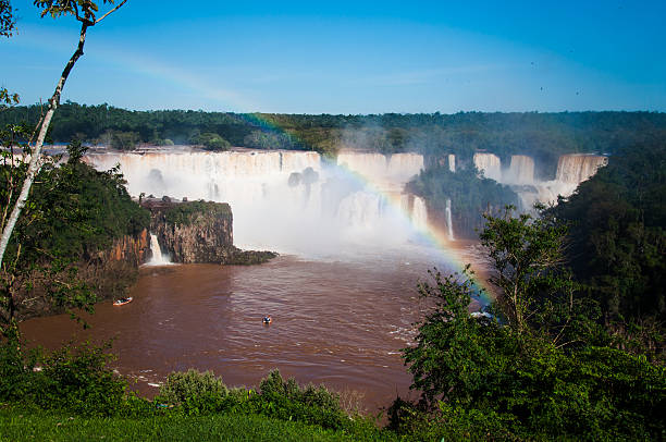 Rainbow over gorgeous waterfalls of Iguazu, Brazil stock photo