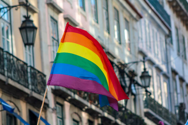 LGBT rainbow pride flag waving in the wind stock photo