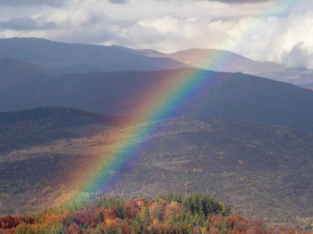 Rainbow seen from the Secaria peak, Prahova County, Romania stock photo