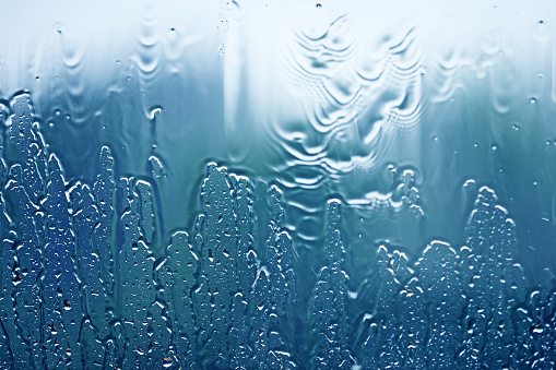 Raining, streams of water on the glass on window