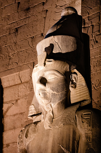 Statue of Ramses II or Ramses the Great at the Luxor Temple in Luxor, Egypt illuminated at night