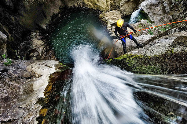 Rappeling down the waterfall stock photo