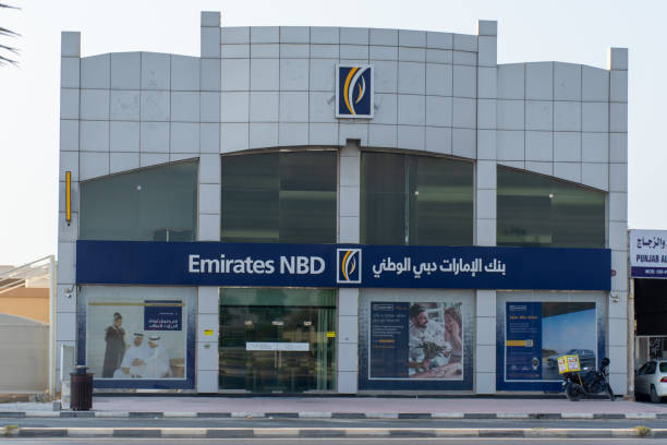 "Ras al Khaimah, Ras al Khaimah/UniEmirates NBD Bank PJSC  Bank (National Bank of Dubai) blue storefront on a blue sky sunny day. " stock photo