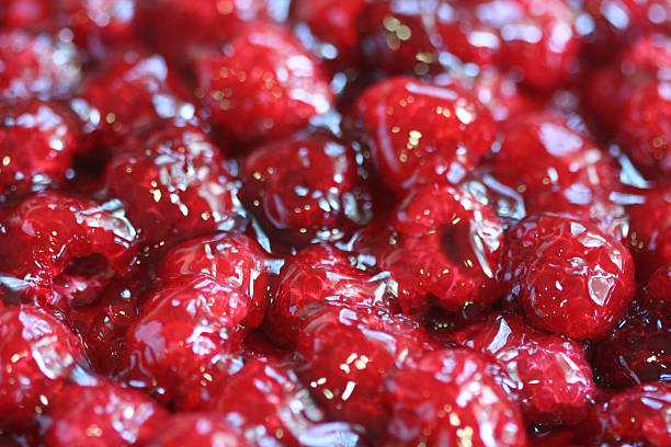 Raspberries pie tart macro on fruits with coulis and gelatin stock photo