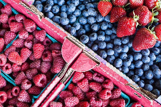 Raspberry blueberry and strawberry on a farmer's market stock photo