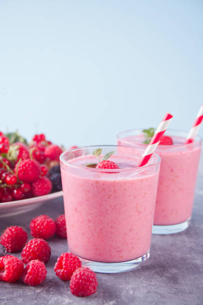 Raspberry smoothies and raspberry fruit on the concrete background stock photo