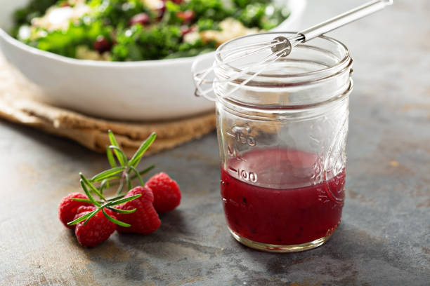 Raspberry vinaigrette salad dressing Fresh and bright raspberry vinaigrette salad dressing green olives jar stock pictures, royalty-free photos & images