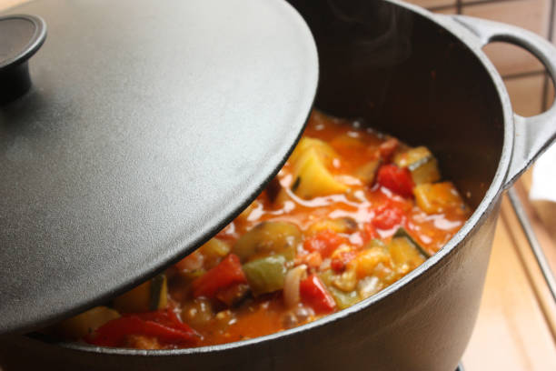 Ratatouille being cooked in a cast iron casserole  French cooking stock photo